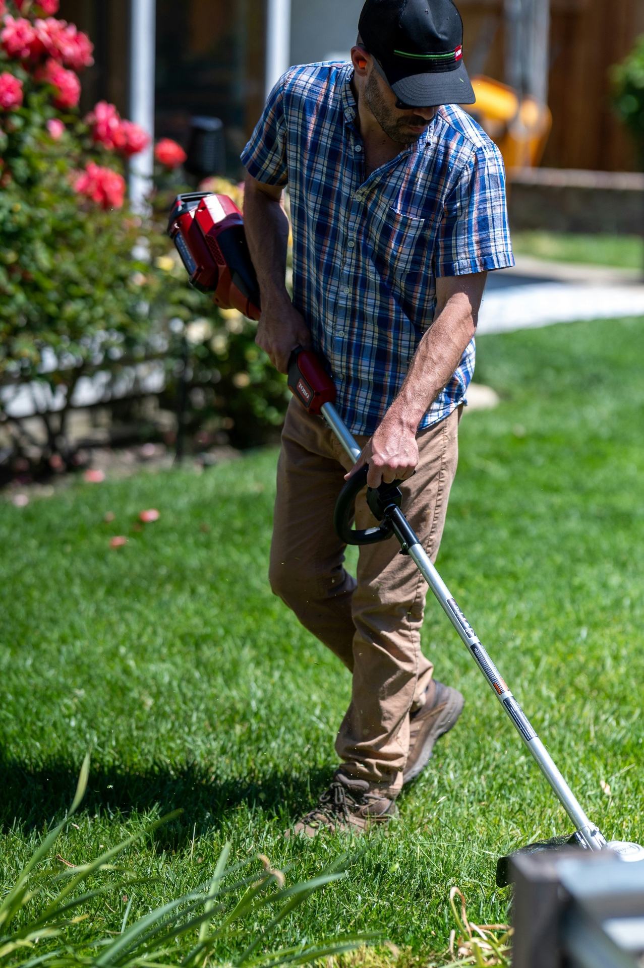 Buildwell crew string trimming edges of a Toronto residential lawn